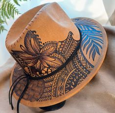 a brown hat with blue and black designs on it