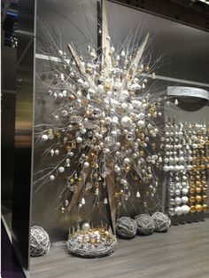 a display case filled with lots of different types of beads and ornaments on top of a wooden floor