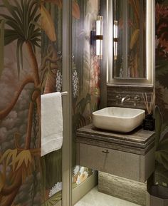 a bathroom sink sitting under a mirror next to a wall