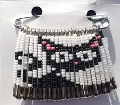 a beaded purse with black, white and pink beads