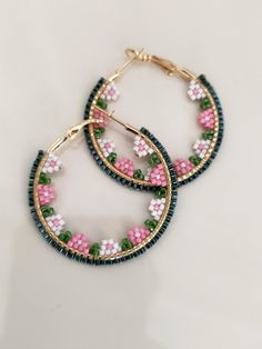 two hoop earrings with pink and green beads