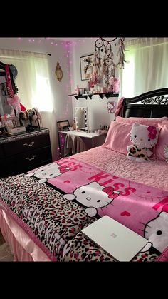 a hello kitty themed bedroom with pink and black decor