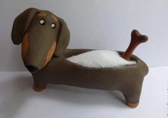 a toy dachshund dog is covered in snow