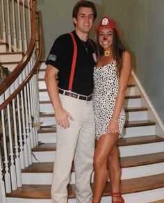 a man and woman are standing on the stairs