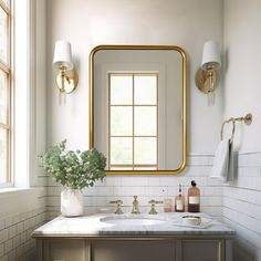 a bathroom sink with a mirror above it and a vase full of flowers on the counter