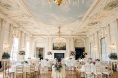 an ornately decorated ballroom with chandeliers and tables