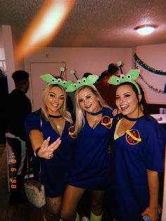 three women dressed in costumes posing for the camera