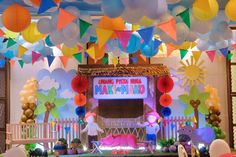 an indoor stage set up for a children's birthday party with balloons and decorations