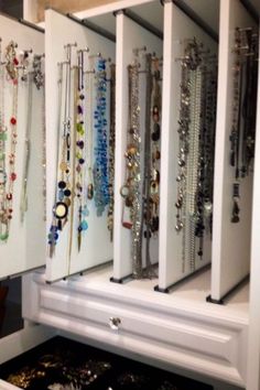 a white cabinet filled with lots of jewelry