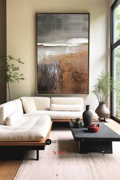 a living room filled with furniture and a large painting on the wall above it's coffee table