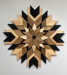 a wooden wall clock with black and brown designs