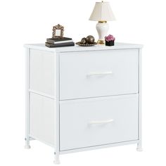 a white night stand with two drawers and a lamp on top of the table next to it