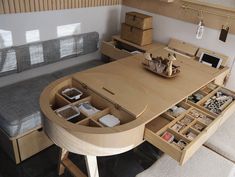 a wooden table with drawers underneath it and a bench in the back ground next to it