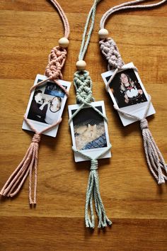 four pictures are hanging on a string with tassels and rope attached to them