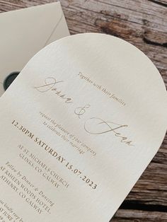 an open wedding program on top of a wooden table