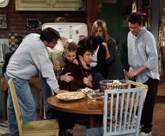 friends gathered around a table in the kitchen