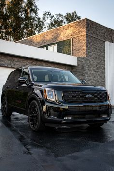 a black suv parked in front of a building