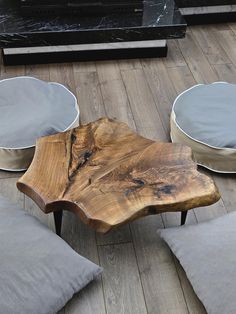 a wooden table sitting on top of a hard wood floor next to two white bowls