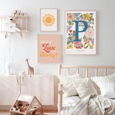 a bedroom with white walls and pictures on the wall