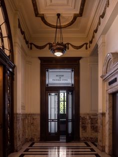 the entrance to an old building with marble floors