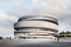 people are walking around in front of a circular building