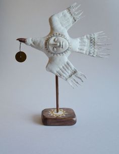 a white bird with an ornament on it's wings