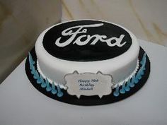 a cake with ford logo on it sitting on a table