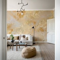 a living room with a couch, coffee table and lamp hanging from the ceiling above it