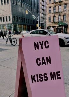 a pink sign that says nyc can kiss me