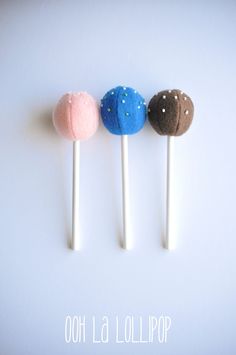 three lollipops with different colors and designs on them