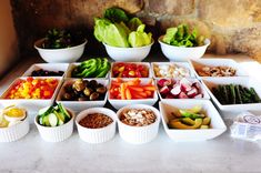 a table topped with bowls filled with different types of vegetables