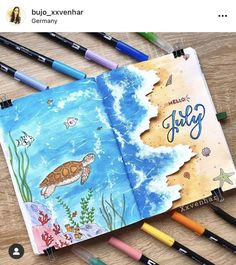 an open children's book with watercolors and pencils next to it