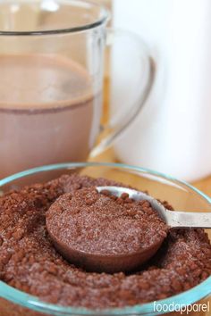 there is a spoon in the bowl next to some chocolate pudding and a pitcher of milk