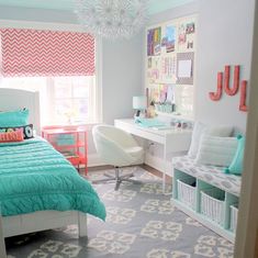 a bedroom decorated in turquoise and white with lots of storage boxes on the bed,