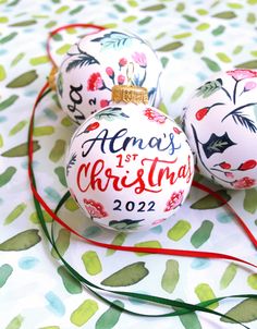 two christmas ornaments are sitting on a table