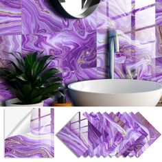 a bathroom with purple marble tiles and a plant in the corner, next to a sink