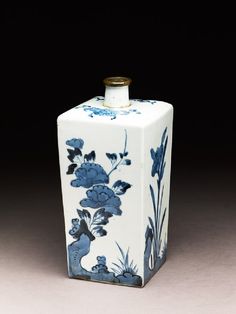 a blue and white vase sitting on top of a table