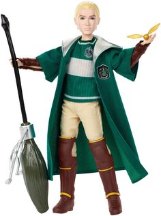 the wizard doll is holding a broom and wearing a green coat with white stripes on it