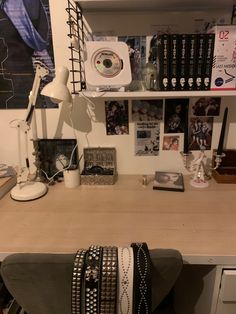 a desk with several bracelets on it and a lamp in the corner next to it