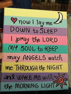 someone is holding up a sign that says, now lay me down to sleep i pray the lord my soul to keep may angels watch