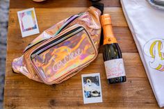 the contents of a bag are laid out on top of a wooden table next to a bottle of wine