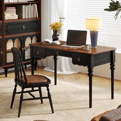 a desk with a laptop on it in front of a bookshelf filled with books