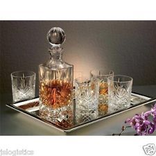 an assortment of glasses and a decanter on a tray