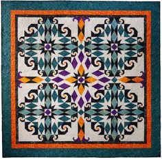 a quilted wall hanging with an intricate design on it's center and sides