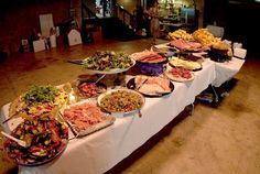 a buffet table filled with lots of different types of food on it's sides