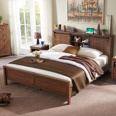 a bedroom with a bed, dressers and two night stands on the floor next to each other