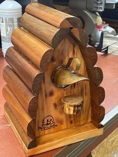 a birdhouse made out of wood on a table