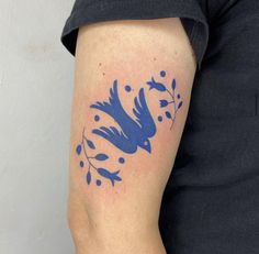 a blue bird tattoo on the right arm