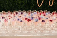 there are many wine glasses lined up on the table for a wedding party or reception