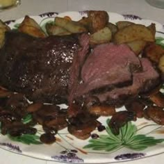 a plate that has some meat and potatoes on it